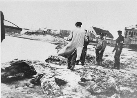 Members of the Kovno ghetto fire brigade pull the bodies of murdered Jews from the Viliya River